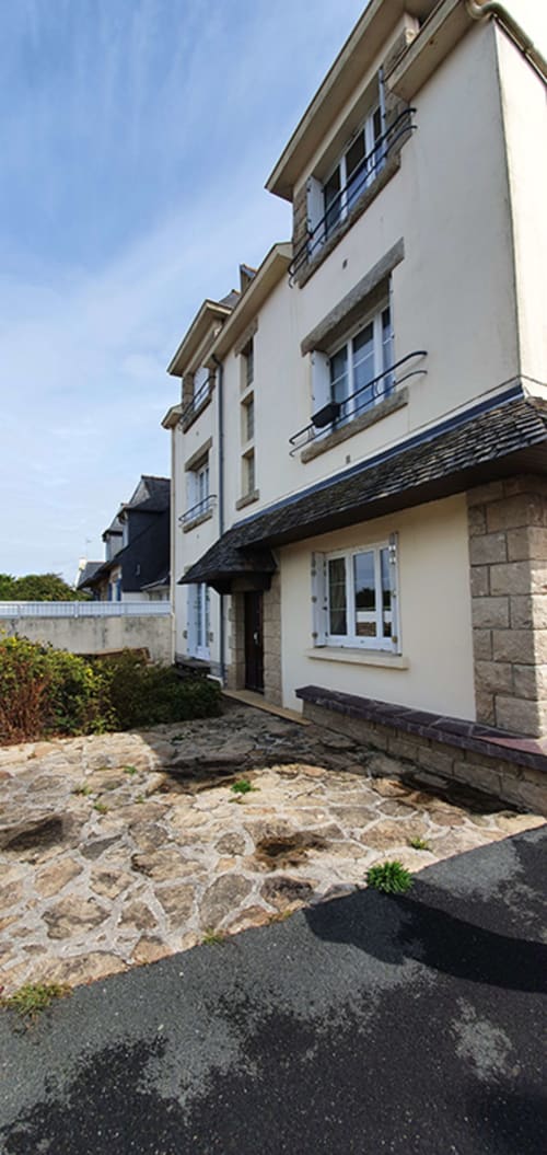 Modern apartment building at Location Vacances Finistère Sud in La Fôret-Fouesnant, France with stone courtyard