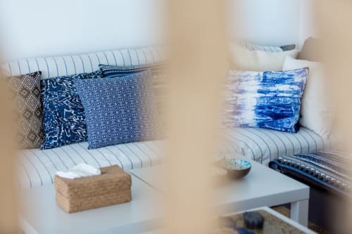 Bedroom with blue patterned pillows, striped bedding, and coastal decor at Indigo Villa Samui, Ko Samui