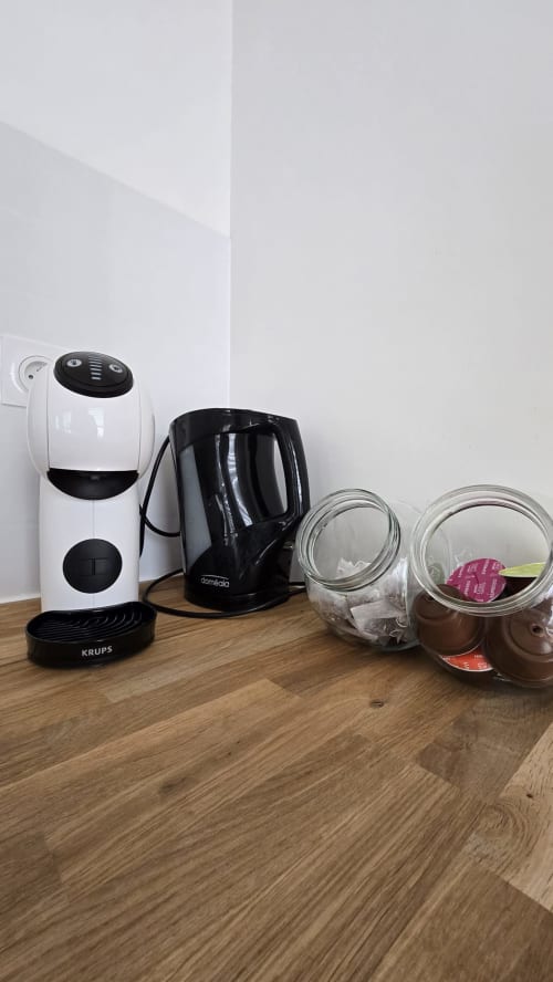Krups coffee maker and kitchen appliances on wooden counter in Ô KASTEL apartment at Location Vacances Finistère Sud