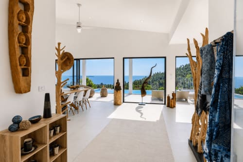 Spacious modern villa interior in Ko Samui with sea views, wooden décor, open-plan living area, and terrace overlooking ocean