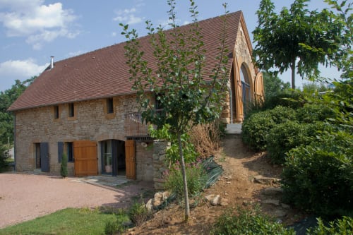 Maison de pierre avec terrasse aux Chambres d'hôtes Les Pratges à Figeac, architecture rustique et jardins luxuriants