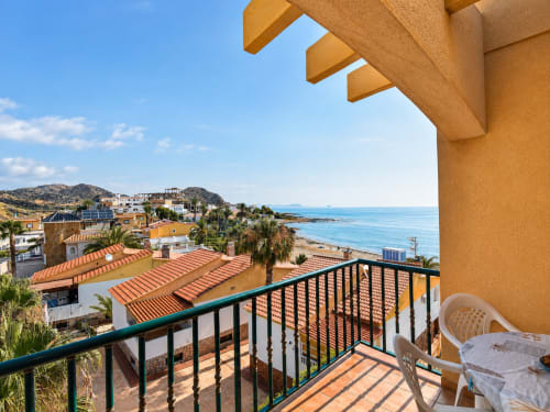 Balcony view of Apartamentos El Calón Playa in Cuevas del Almanzora with sea views, terracotta roofs, and Mediterranean