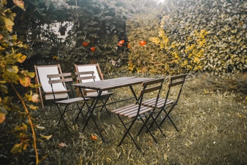 Espace de restauration en plein air à la maison d'hôtes ART DE VOYAGER à Étretat avec table, chaises et fleurs éclatantes
