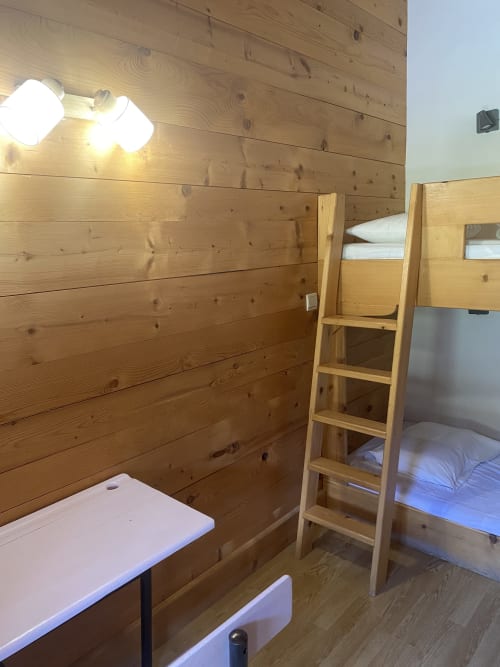Chambre de chalet en bois avec lits superposés, bureau et appliques murales à La Ferme des Georgières, Notre-Dame-de-Bellecombe