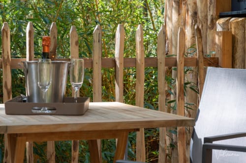 Une terrasse extérieure dans un écrin de verdure.