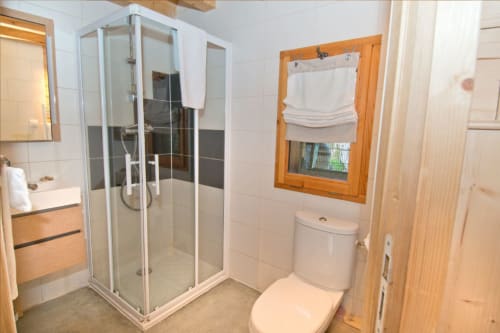 Salle de bain privée avec douche, toilettes et fenêtre en bois à l'Auberge Nemoz au Haut-Bréda, France