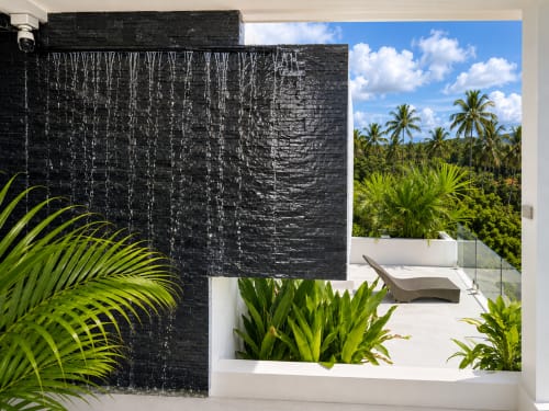Modern outdoor shower with black brick wall and tropical view at Indigo Villa Samui, Ko Samui