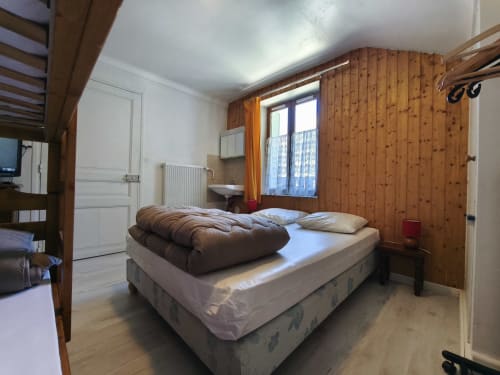 Camera accogliente nello Chalet Coste Belle a Ceillac con pareti in legno, letto matrimoniale, vista montagna e comfort moderni