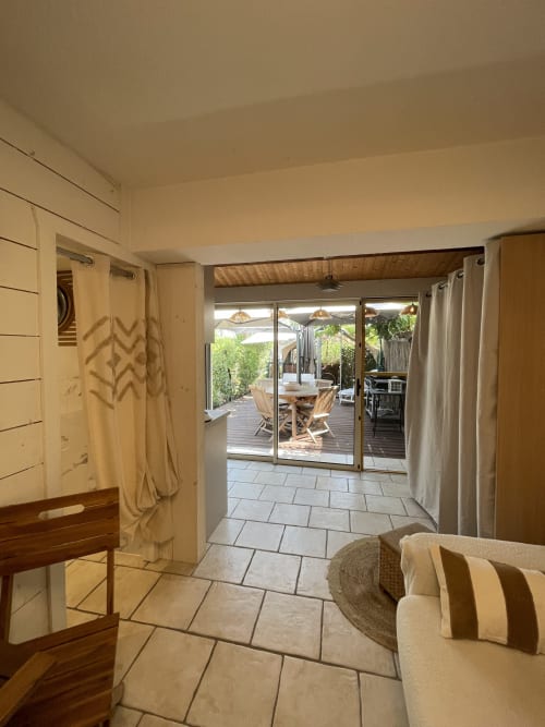 Spacieux séjour lumineux à La Montagnette Cap D'Agde avec portes vitrées ouvrant sur jardin et terrasse