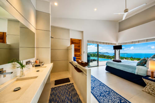 Modern villa bathroom with sea view, Indigo Villa Samui, Ko Samui. Twin vanity, ocean landscape visible through windows.
