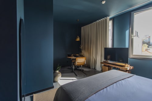 Modern Superior One-Bedroom Apartment at Benefit Collection hotel in Porto with teal walls, bed, TV, work desk, and garden