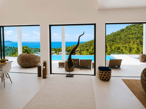 Modern luxury villa in Ko Samui with open-plan living, sea views, infinity pool, and lush tropical surroundings