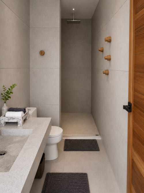 Modern bathroom in Indigo Villa Samui with toilet, sink, and walk-in shower with rainfall head and wooden fixtures