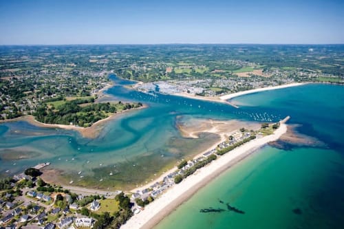 Aerial view of Cap Coz beach in La Forêt-Fouesnant, Brittany, with turquoise waters and sandy shores near the vacation rental