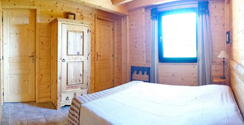 Cozy wooden cottage bedroom at Chalet La Louvière with mountain view, double bed, and bright window