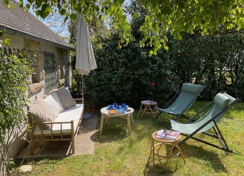 Espace de détente au jardin de la villa Mer et Maisons à La Trinité sur Mer avec transats, lit de jour et parasols