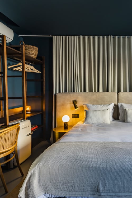 Deluxe Double Studio at Benefit Collection Porto with double bed, brass headboard, striped curtains, and wooden bunk beds