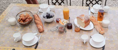 Petit-déjeuner en plein air au cottage Chez Laure & Marc à Plaissan avec croissants, pain, fruits et boissons au jardin
