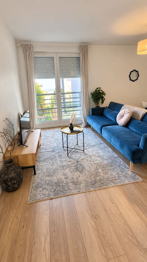 Canapé bleu moderne avec vue sur balcon à L'escapade parisienne, Le Paradis Des Logis, Argenteuil