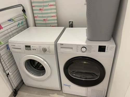 Laundry room at Les Gites De Flaubert villa with Bosch washing machine and Beko dryer in Le Héron, France