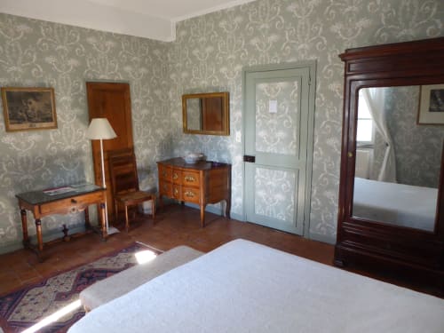 La Tour bedroom at Domaine de Lamartine B&B in Pont-Saint-Esprit with period furniture, damask wallpaper, and garden views