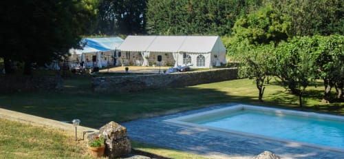 Domaine de Lamartine swimming pool and white event tent in Pont-Saint-Esprit garden setting