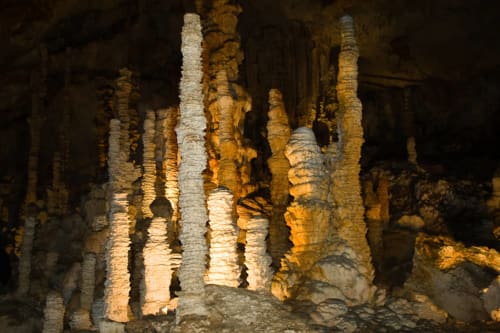 Stalactites and stalagmites formations inside an underground cave at Domaine de Lamartine, Pont-Saint-Esprit
