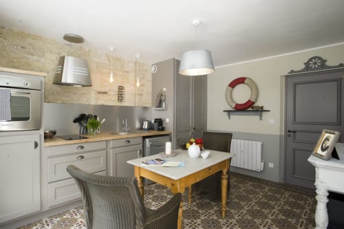 Coastal kitchen and dining area at Les Filles du Bord de Mer, Port-en-Bessin with nautical décor