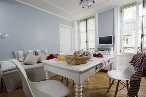 Bright studio at Les Filles du Bord de Mer with seating area, white table, and coastal Normandy views