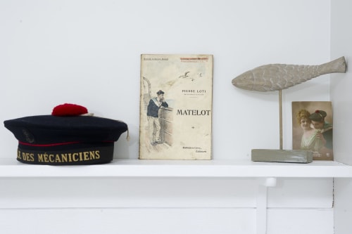 Nautical shelf display at Les Filles du Bord de Mer hotel featuring French maritime decor and vintage collectibles