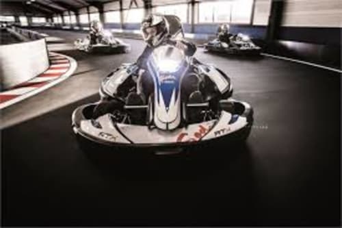 Go-kart racing at indoor track near Maison Addama B&B in Neyron, France