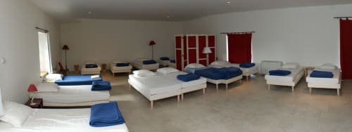 Showroom display of beds with blue and white bedding at Domaine de Lamartine B&B in Pont-Saint-Esprit, France