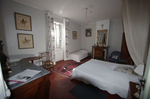 Spacious bedroom at Domaine de Lamartine B&B in Pont-Saint-Esprit with two beds, wooden furniture, and garden views