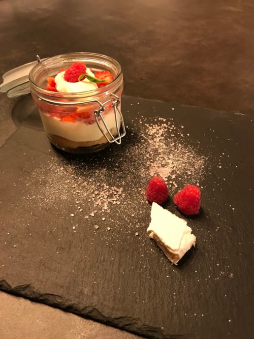 Gourmet dessert with raspberries and cream in glass jar at Le Pignié boutique hotel, Lescure-d'Albigeois