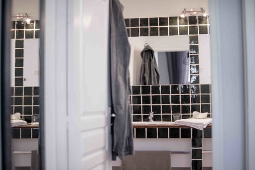 Salle de bains moderne avec carrelage métro noir, vasque blanche et porte-serviettes à la Chambre d'hôtes Le Pignié à Lescure-d'Albigeois