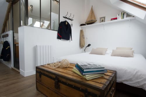 Schlafzimmer Le Loft du Matelot mit weißen Wänden, Segelboot-Dekoration, Holztruhе und Nautik-Möbeln bei Les Filles