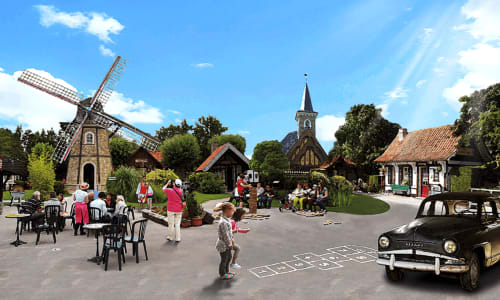 La Ferme Du Grand Air, un village de charme avec moulin, église, voiture vintage et familles profitant d'activités en plein air