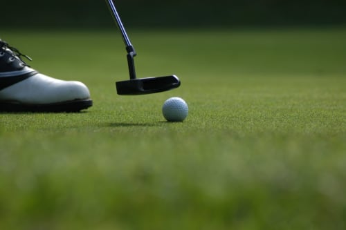 Golfer preparing to putt on green at Chalet Du Bel Event, La Chapelle-sur-Dun