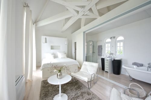 Suite de luxe au Château de Baylac avec salle de bains privée, équipements modernes et décor blanc élégant