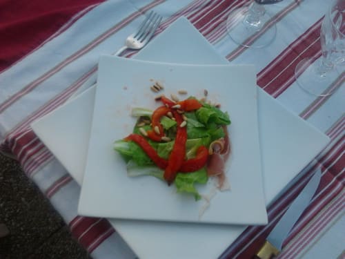 Salad of fresh peeled peppers, Parma ham and pine nuts.