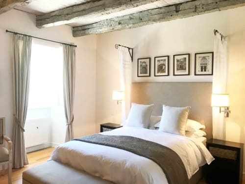 Elegant bedroom at Manoir De Rieuzal B&B in Loubressac with exposed beams, queen bed, and garden views
