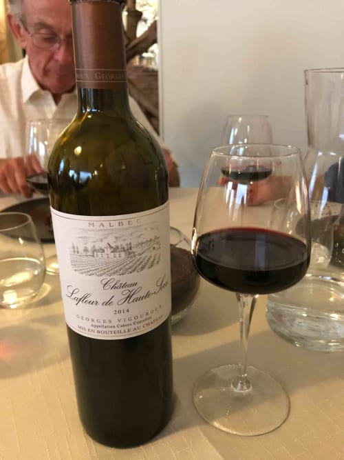 Malbec wine tasting at Manoir De Rieuzal, Loubressac France with glass and vintage bottle
