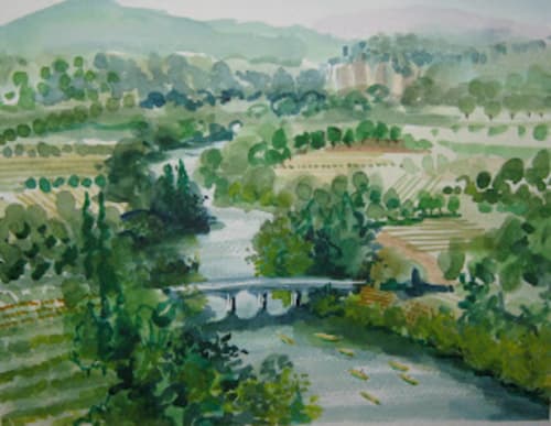 Scenic river valley landscape with bridge, trees, and medieval castle ruins in distant Loubressac, France