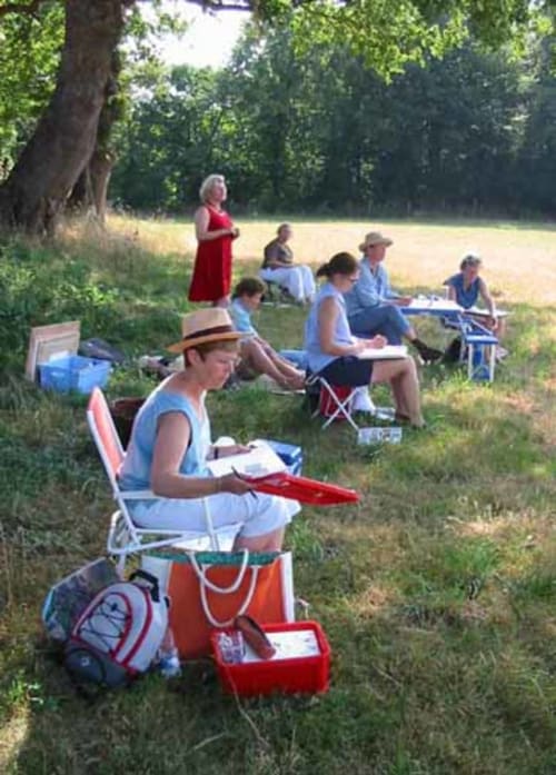 Outdoor picnic gathering at Manoir De Rieuzal in Loubressac, guests dining under trees