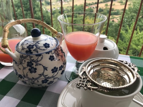 Tea service with porcelain pot overlooking Loubressac countryside at Manoir De Rieuzal