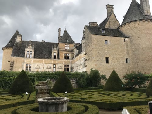 Manoir De Rieuzal medieval castle with manicured gardens and topiary in Loubressac, France