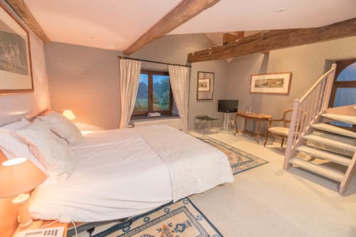 Luxury bedroom with exposed wooden beams at Château d'Hassonville, Marche-en-Famenne, Belgium