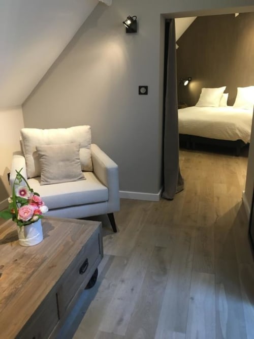 Annex King Room at Le château d'Hermonville: seating area with armchair, bed, wooden flooring, modern décor