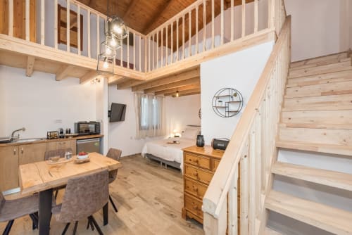 Spacious loft studio at Villa Freedom with mezzanine, kitchenette, and bedroom area in Kokkino Chorio, Crete
