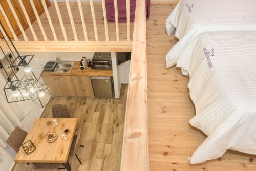 Villa Freedom studio apartment in Crete with kitchenette, dining table, and two beds with white linens